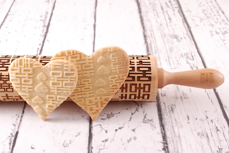 Laser engraved wooden rolling pin to emboss designs on cookies